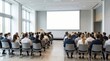 © Pavel - Large group of business people sitting in a modern bright conference hall with blank white projector screen mockup for presentation