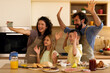© djile - Family taking selfie celebrating breakfast togetherness in kitchen