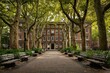 © Popelniushka - Brick college campus building bathed in warm sunlight among tree-lined grounds
