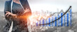 © InfiniteFlow - A confident businesswoman stands against a vibrant city backdrop, symbolizing growth and achievement in a dynamic market through a visual graph representation. Impute
