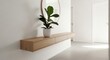 © Yudi - Minimalist entryway featuring a floating wood console shelf with a potted plant and a round mirror