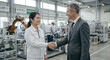 © Pukan - Japanese female engineer shaking hands with businessman in modern automated factory with industrial robots.