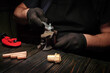 © Віталій Б. - A person mechanic uses a wrench to tighten a fitting on copper pipes while seated at a workbench in the evening. Tools lay nearby, showing various plumbing tasks in progress