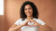 © Niks Ads - Happy Young Woman Making Heart Shape with Hands