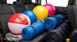 © Olga - Backseat stuffed with beach balls and rolled sleeping bags for family road trip