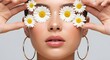 © Cradle Creative Co - A woman with flowers covering her eyes and gold hoop earrings