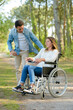 © auremar - young couple in wheelchair strolling in the countryside