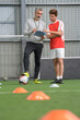 © auremar - soccer coach and a football player checking the plan