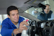 © auremar - professional handsome man cleaning car