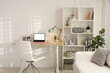 © New Africa - Stylish workplace with modern laptop on wooden desk in office