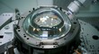 © Nova Visuals - Photorealistic macro aerospace cleanroom robotic polishing massive convex glass satellite lens.