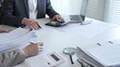 © rogerphoto - Accountants processing financial documents and taxes, managing corporate finance in a modern office. Audit and taxes in business