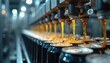 © miss irine - Automated line fills metal cans with golden fizzy liquid. Beverage production process in a factory. Machines work fast filling drinks for mass consumption.