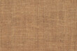 © ZHOU - Brown burlap cloth background or sack cloth for packing. Natural linen threads texture. Sackcloth, empty space. Wrapping detail, old grainy cotton backdrop close-up.