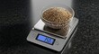 © YENI - Close-up of a digital scale with a bowl of grains, measuring weight accurately.