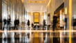 © Akbar - Blurred figures move through a grand, illuminated hotel lobby with reflective floors