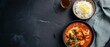 © Marta P. (Milacroft) - Top View of Classic Indian Butter Chicken With Basmati Rice In Rich Creamy Curry Sauce, Contemporary Heritage Style Food Photography With Copy Space