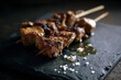 © Marta P. (Milacroft) - Portuguese espetadas with grilled beef cubes on skewers, serving on a black slate plate with rock salt