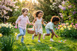 © Michalis Palis - Kids searching for Easter eggs in a blooming garden with vibrant flowers and warm golden light.