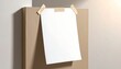 © andre - A clean, blank white sheet of paper is attached with tape to a brown cardboard box in a well-lit setting