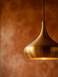 © ALL YOU NEED studio - Modern brass pendant lamp with warm diffused light on textured terracotta wall, luxury interior macro