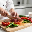 © Rocky - Professional chef slicing raw beef steak on wooden cutting board