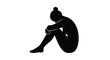 © PrimePixel Studio - Abstract black silhouette of a person sitting curled up and hugging their knees in deep thought.