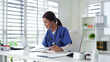 © Pichsakul - Asian adult female medical professional nurse doctor work laptop digital data healthcare records study online telemedicine consultation clinic office