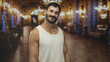 © Krakenimages.com - Man hispanic middleaged with beard wearing a tanktop, smiling and showing bare shoulder while standing in an ornate palace building interior; casual confidence.