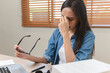 © Pormezz - Young adult asian woman have a eyes tired after overworked looking at screen too much.