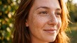 © Thumbs - Young woman with freckles smiling in golden hour sunlight outdoors