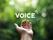 © Jumpei - 新緑の明るい森を背景にVOICEという文字と手のひらを差し出すコミュニケーションのイメージ