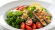 © MDSUMON - Grilled chicken breast salad with quinoa kale avocado slices cherry tomatoes and a lemon wedge in a white ceramic bowl