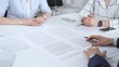 © volha_r - Business partners discussing contract terms, reviewing legal documents during an office meeting, focusing on agreement details and professional negotiation strategies