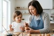 © Tima - Grandmother and toddler grandchild painting Easter egg at home kitchen. Creative family activity for holiday celebration. Seasonal craft hobby with elderly woman and little child together.