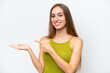 © luismolinero - Young caucasian woman isolated on white background holding copyspace imaginary on the palm to insert an ad