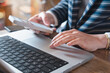© Anchalee - Business professional using smartphone to review financial news and research for funding approval,bookkeeping and accounting tasks at home,overtime deadline concept with digital finance and audit work