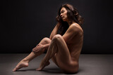 Naked woman Yoga on black background. Fine art photo of female body.	