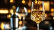 © Muhammad - Crystal wine glass filled with white wine on a bar table indoors