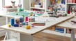 © Hafiz - A cluttered crafting table brimming with art supplies and creative materials, perfect for inspiring handmade projects and DIY endeavors.