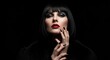 © andi - Portrait of a woman with dark hair, makeup, red lips, and black fur