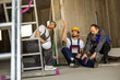 © Mediteraneo - Injured worker explaining a ladder fall to colleagues on a construction site.
