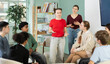 © JackF - Teen group sit in circle and listen to girl classmate speaking, teacher watching. Acting masters courses, stage speech courses, public speaking courses