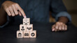 © vittaya - Businessman pointing at wooden blocks with justice scales and legal icons for corporate governance.