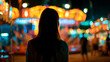 © Moddy - A young woman stands silhouetted against the vibrant, bokeh-filled lights of a carnival at night. Her back is to the camera as she gazes at the illuminated rides and attractions.