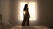 © Husein - Woman silhouette standing near window with sunlight interior design concept