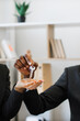© sofiko14 - An African American person hands a key to another person, symbolizing a new beginning or successful transaction