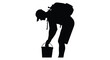 © MIRAJ02 - Hiker bending to examine a bucket depicted in striking black silhouette