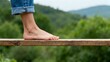 © Deff - Person balancing on wooden plank outdoors