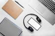 © Kotiryna - Flat lay of laptop, smartphone, headphones and stationery on white background